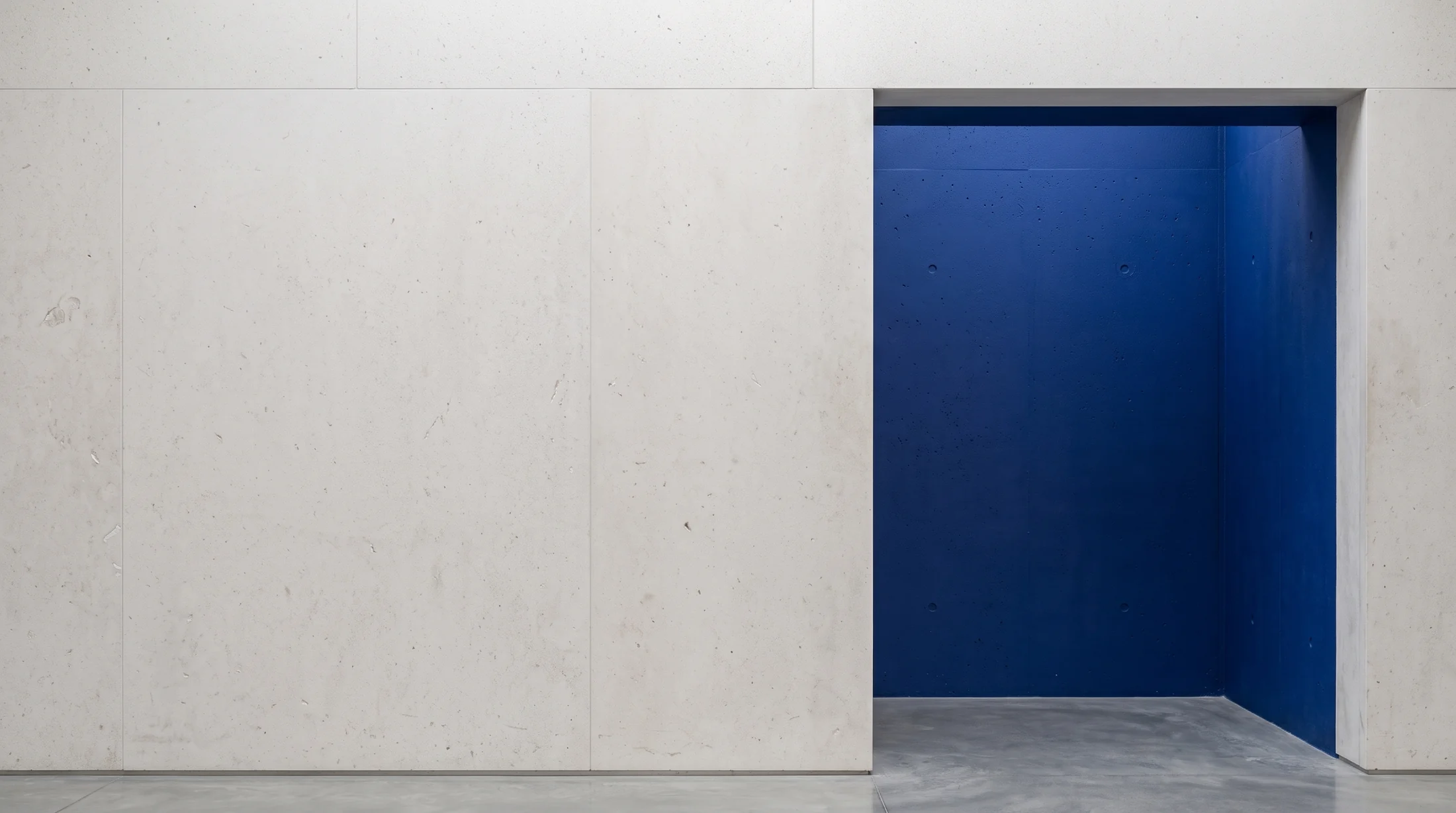 An ultramarine alcove in a limestone wall