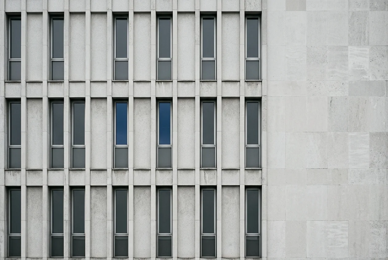 Modernist stone façade with two ultramarine window panes